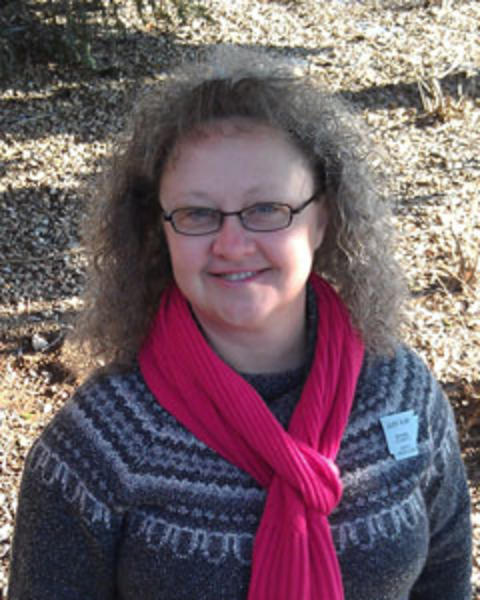 Judy Kay Harris wearing red scarf and sweater