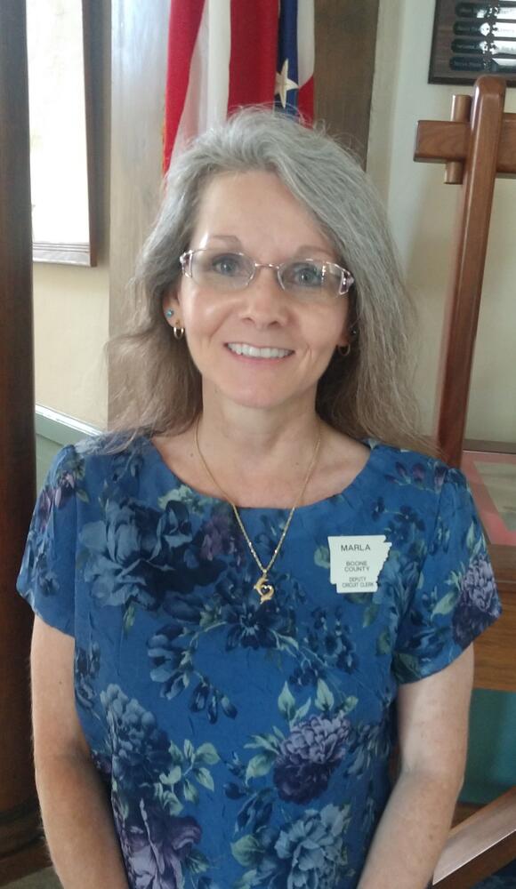 Marla wearing a blue shirt with flower print